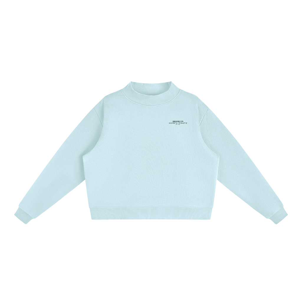 Brooklyn Mock-Neck Crew — Black Text in Light Blue, front view showing the small black BROOKLYN chest print